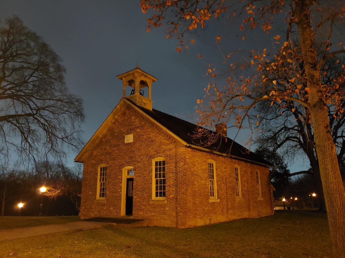 Small red brick building with bell tower