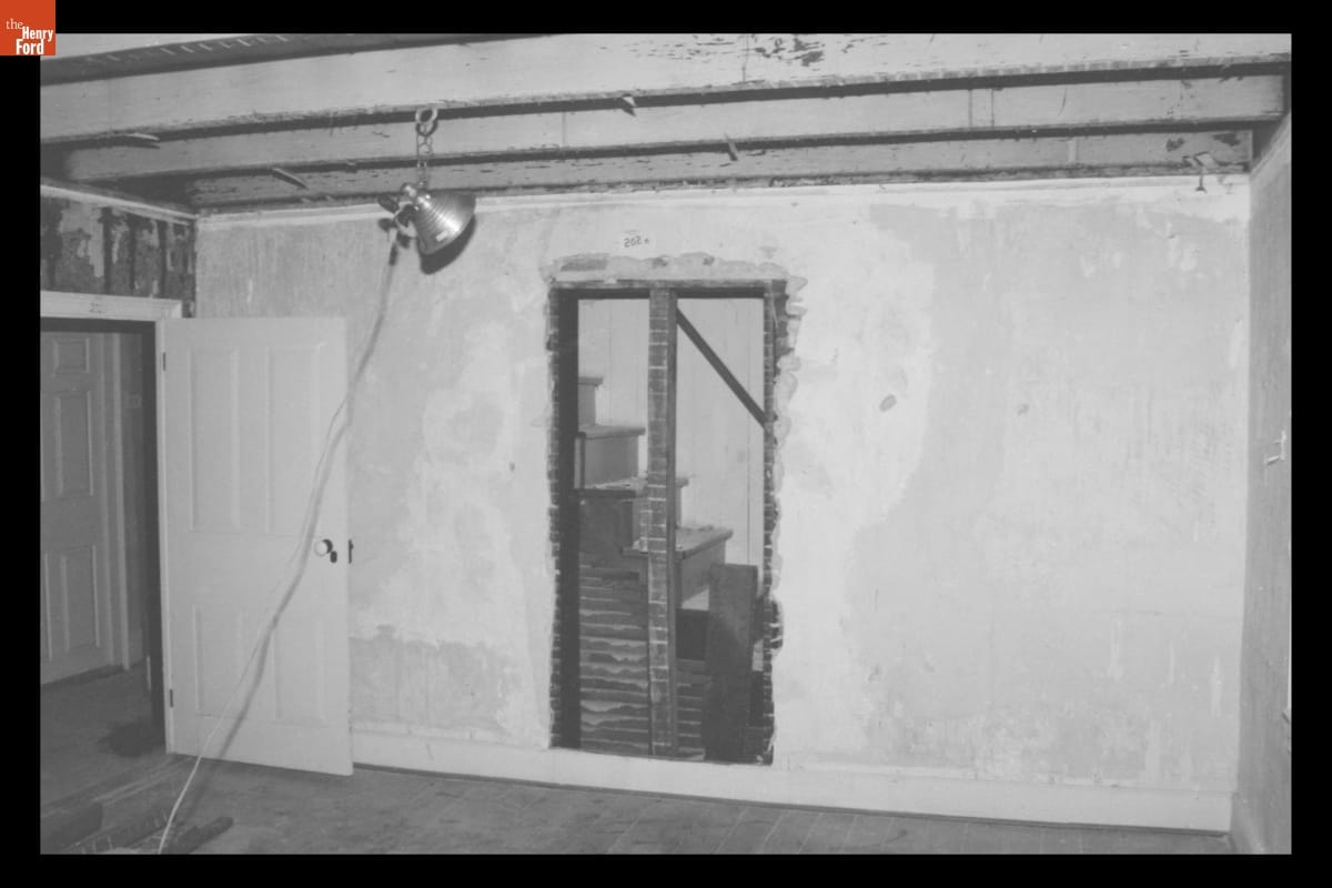 Doorway Uncovered during Dismantling of the Firestone Farmhouse on its Original Site, August 1983 Unfinished wall with open door-shaped hole in it