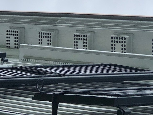 Mutules on the Webster House Architectural elements of white boxes with round holes in a