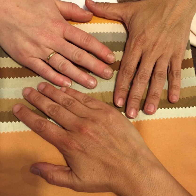 Hands of Sonia Sanchez, Carment Alonso, and Maite Macias Three hands of varying skin tones