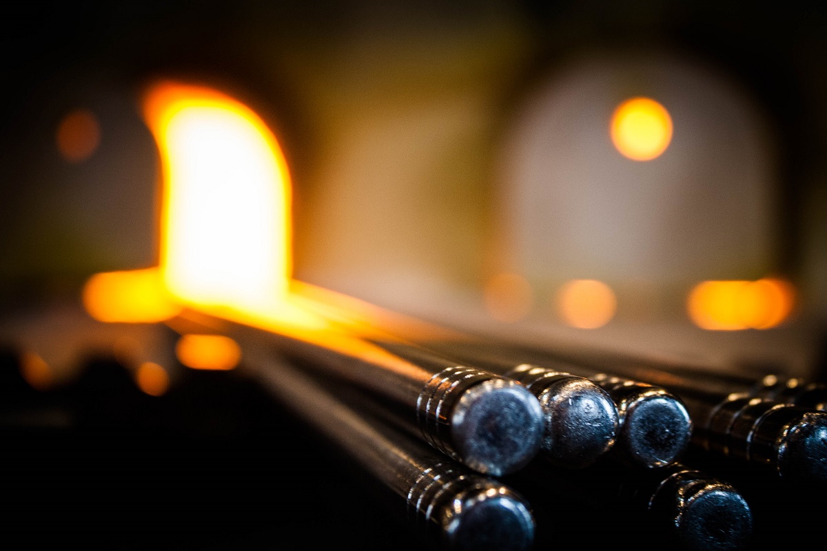 In the Greenfield Village Glass Shop Metal rods with flame visible in the out-of-focus background