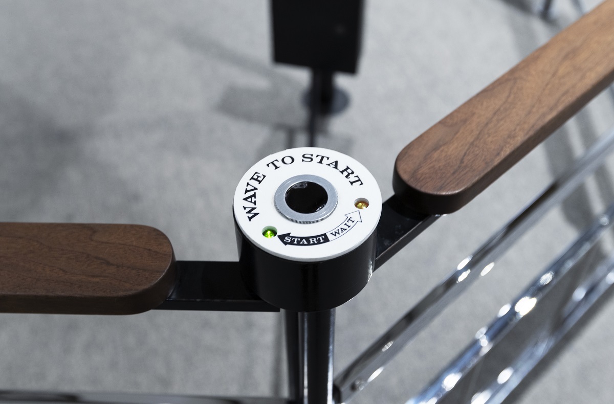 Mathematica’s Moebius Band modified to be touch-free Metal and wood railing with a white sensor mounted on it, with text reading