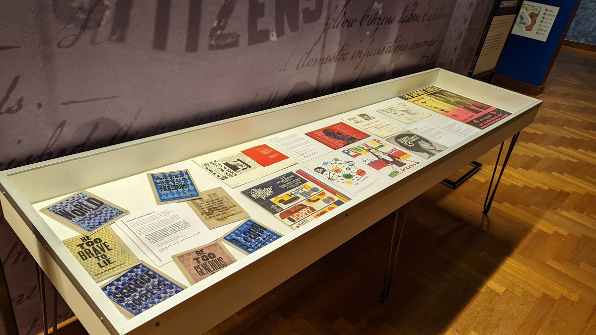 Quiet & Loud pop-up exhibit in Henry Ford Museum of American Innovation Display case containing many colorful flat paper items