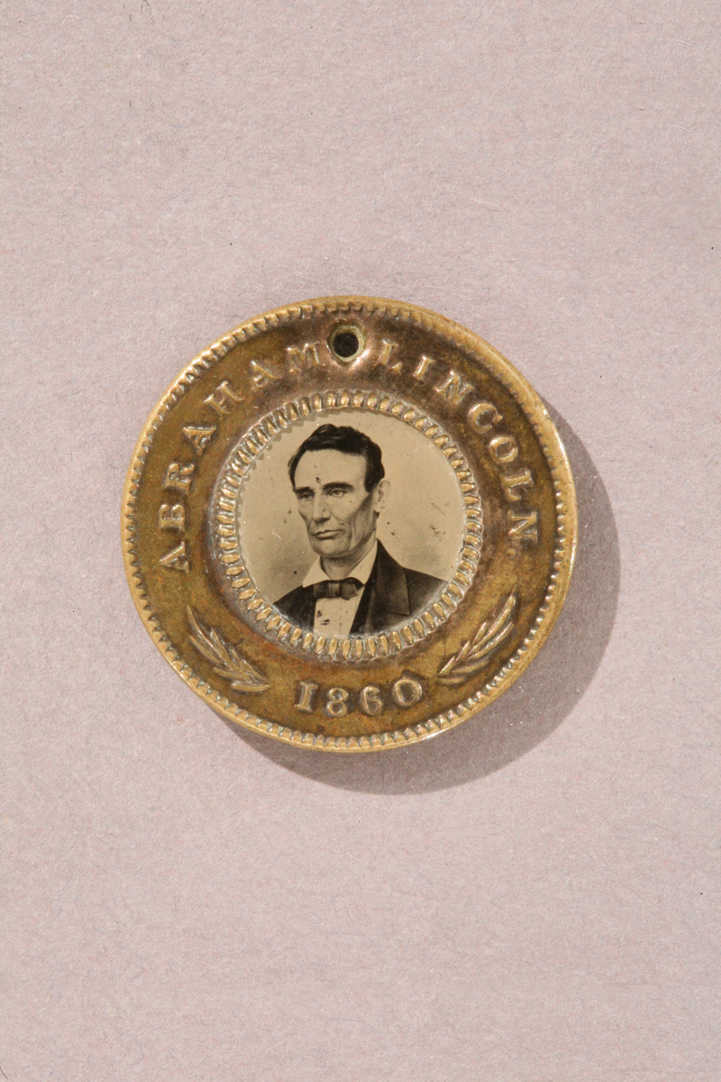 Abraham Lincoln and Hannibal Hamlin Campaign Button, 1860 Gold colored button with text
