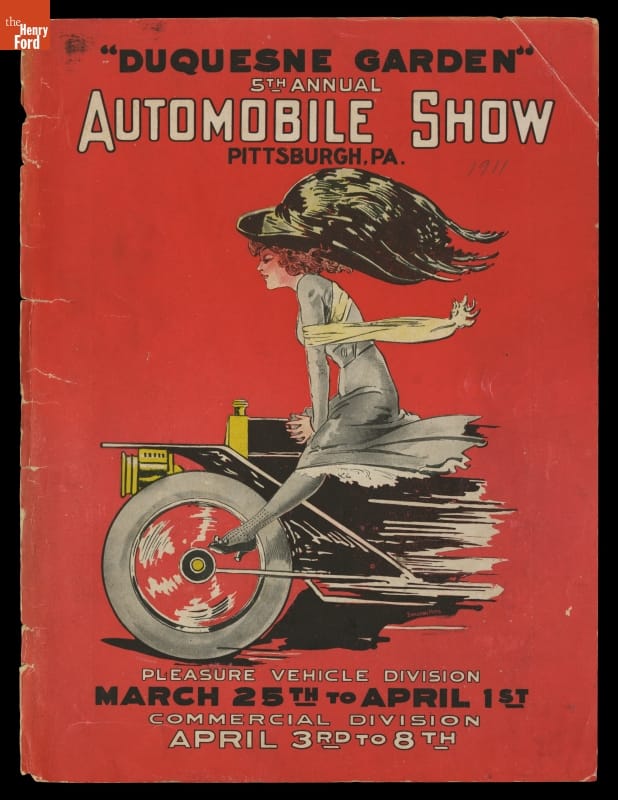 Image of front end of car with a woman in a large hat straddling it on a red background; contains text