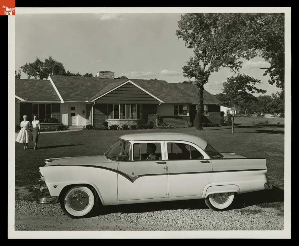1955 Ford Fairlane Town Sedan Black-and-white photo of 50s car parked in front of a lawn and house