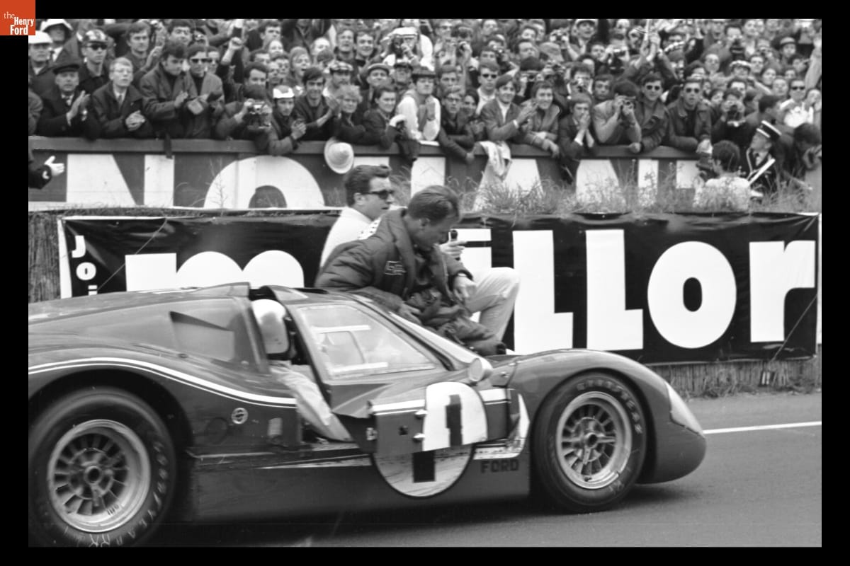 thf127989 A.J. Foyt driving the #1 Mark IV with Dan Gurney riding the windshield to celebrate their win.