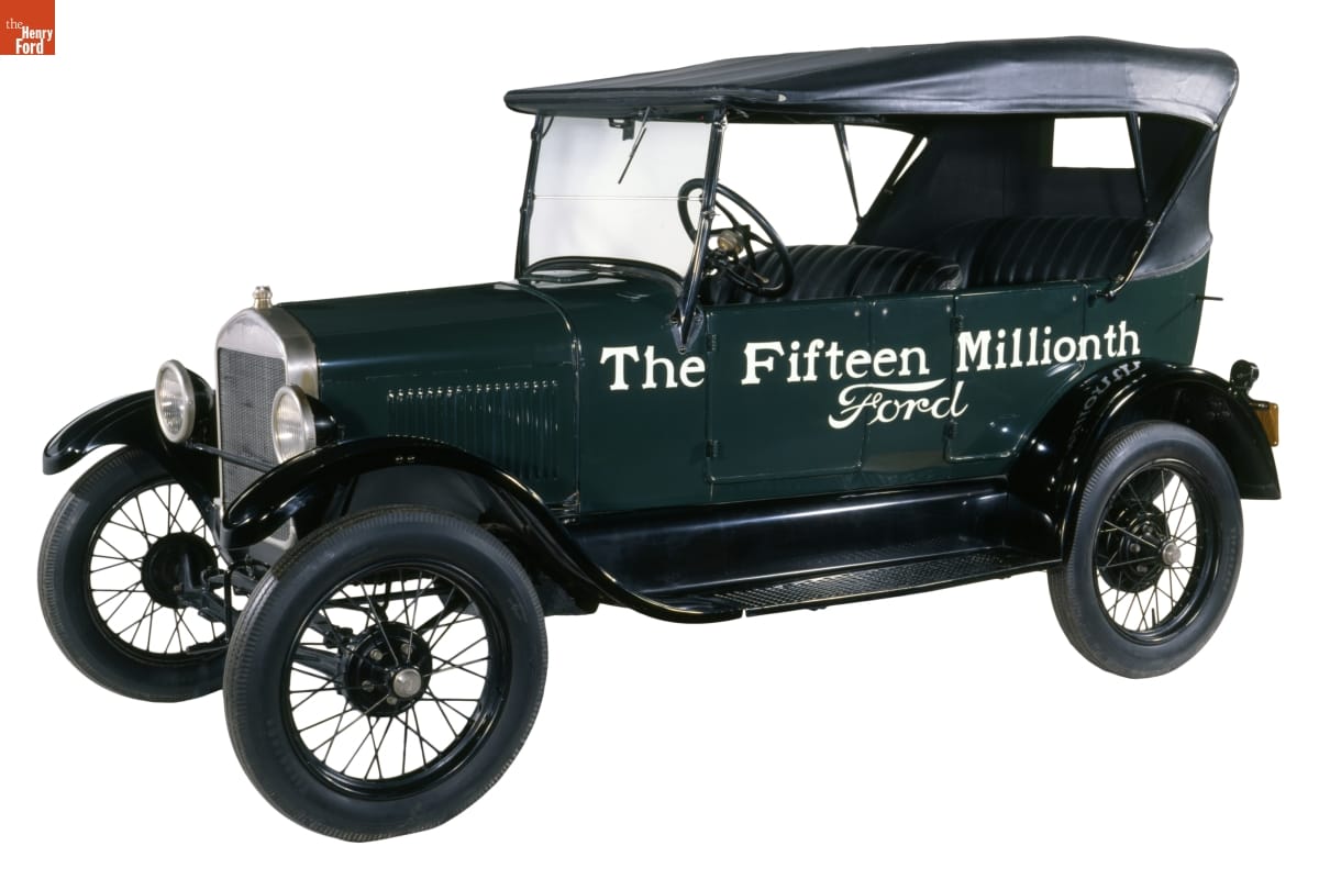 Green car with black top, with text on side: 