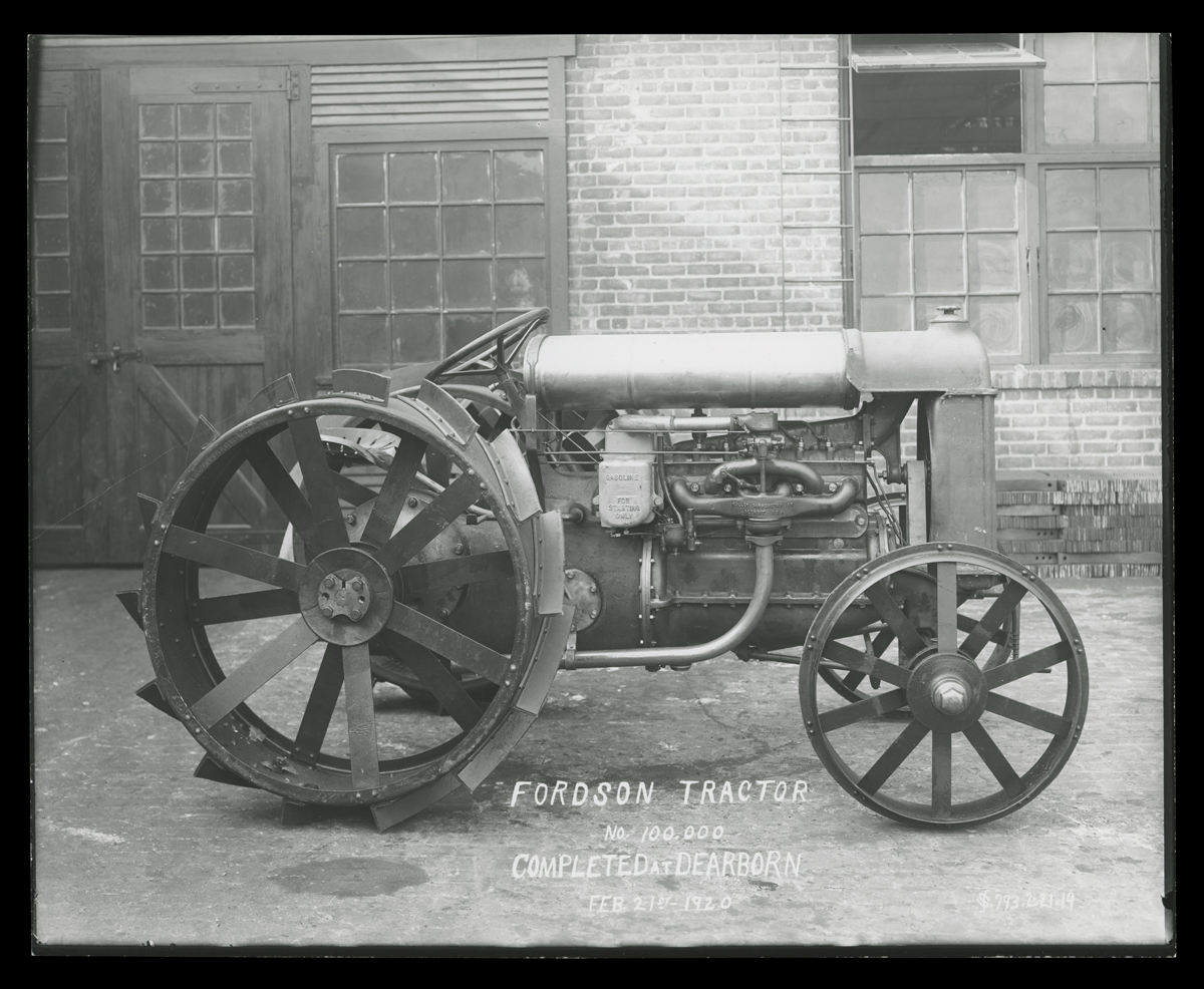 A tractor sits in front of a building
