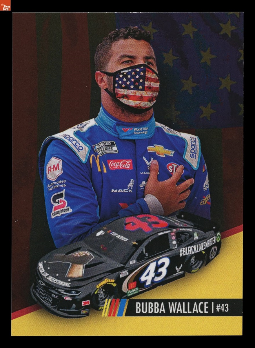 Illustration of man in blue jumpsuit wearing American flag face mask with hand over heart, above illustration of black race car; also contains text