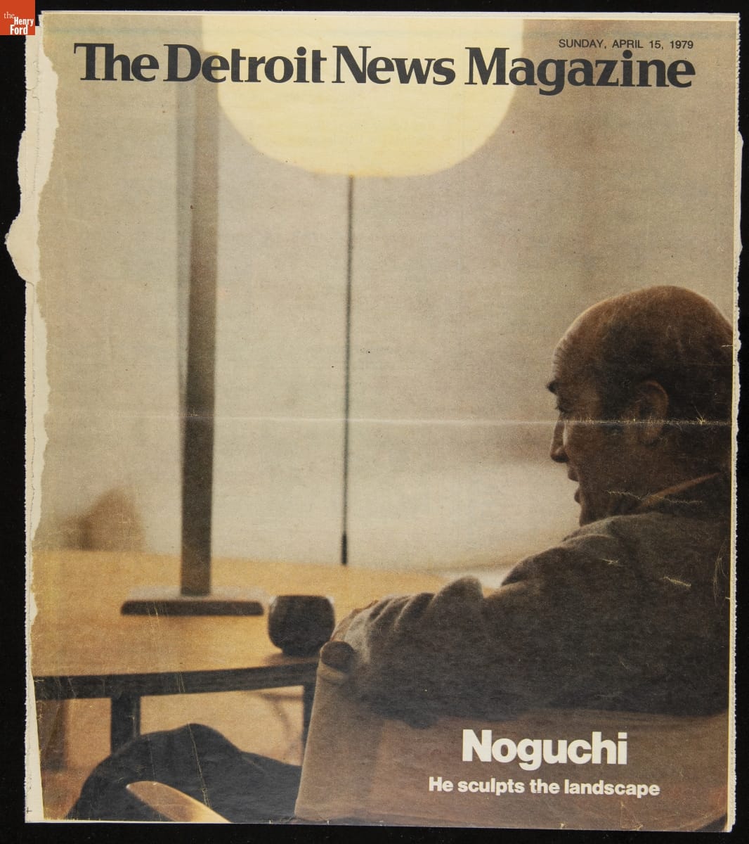 The Detroit News Magazine, Page with text and image from behind/side of man sitting in a chair at a table with a globe-shaped lamp behind it