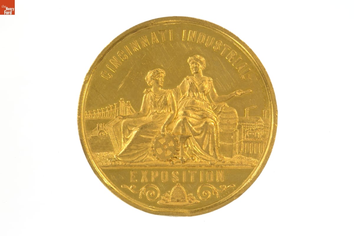 Cincinnati Industrial Exposition Medal Awarded to B. W. Payne & Sons, 1882 Gold coin with text and illustration of two women in classical robes with other items around them