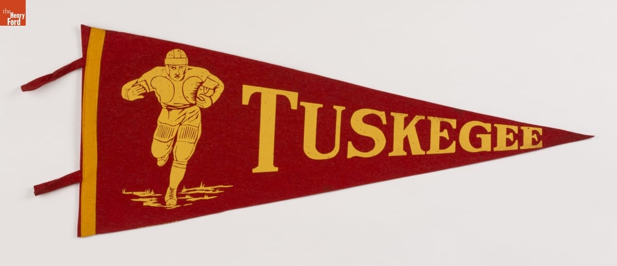 A red pendant showing an illustration of a football player