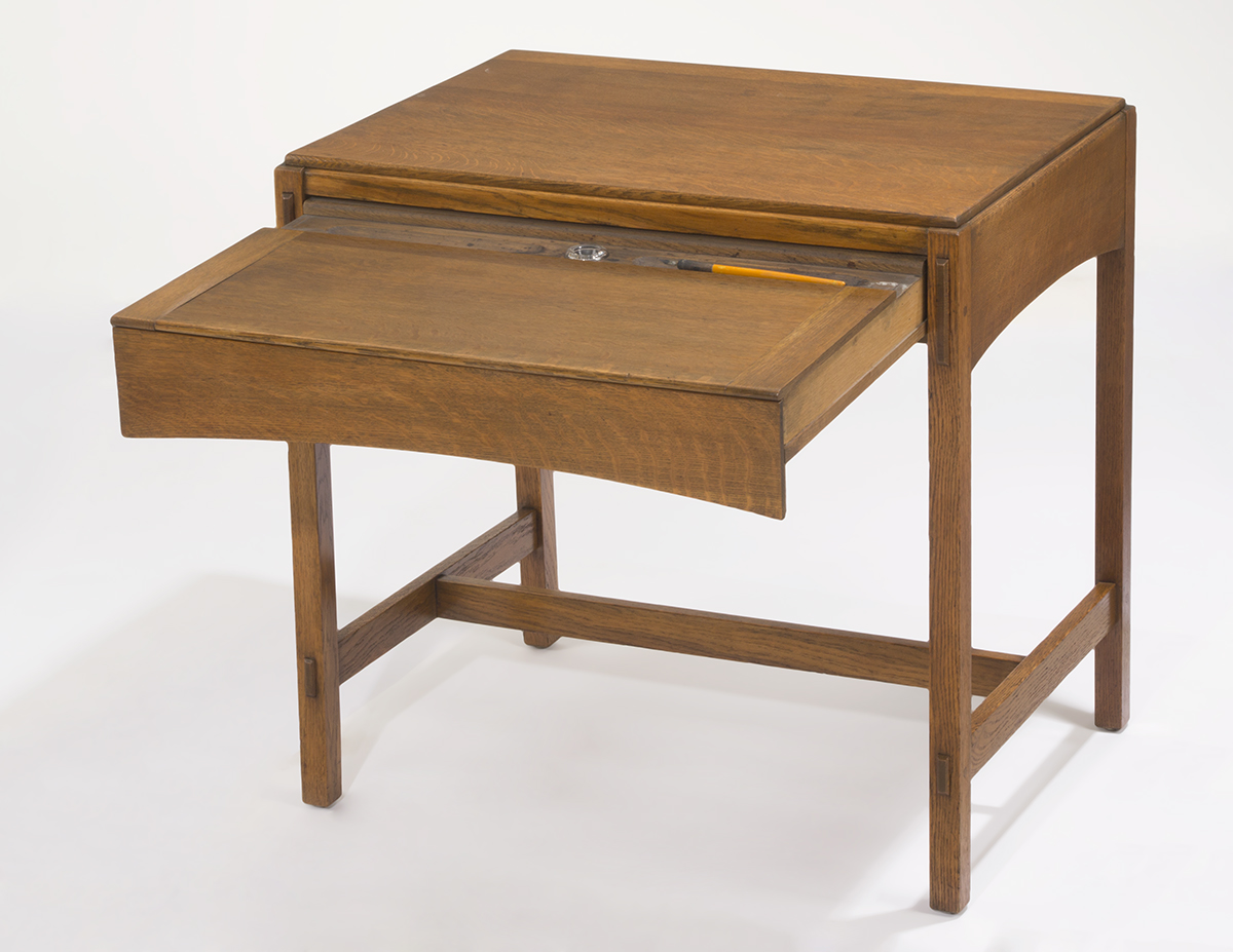 Wooden table with piece extended to form writing surface