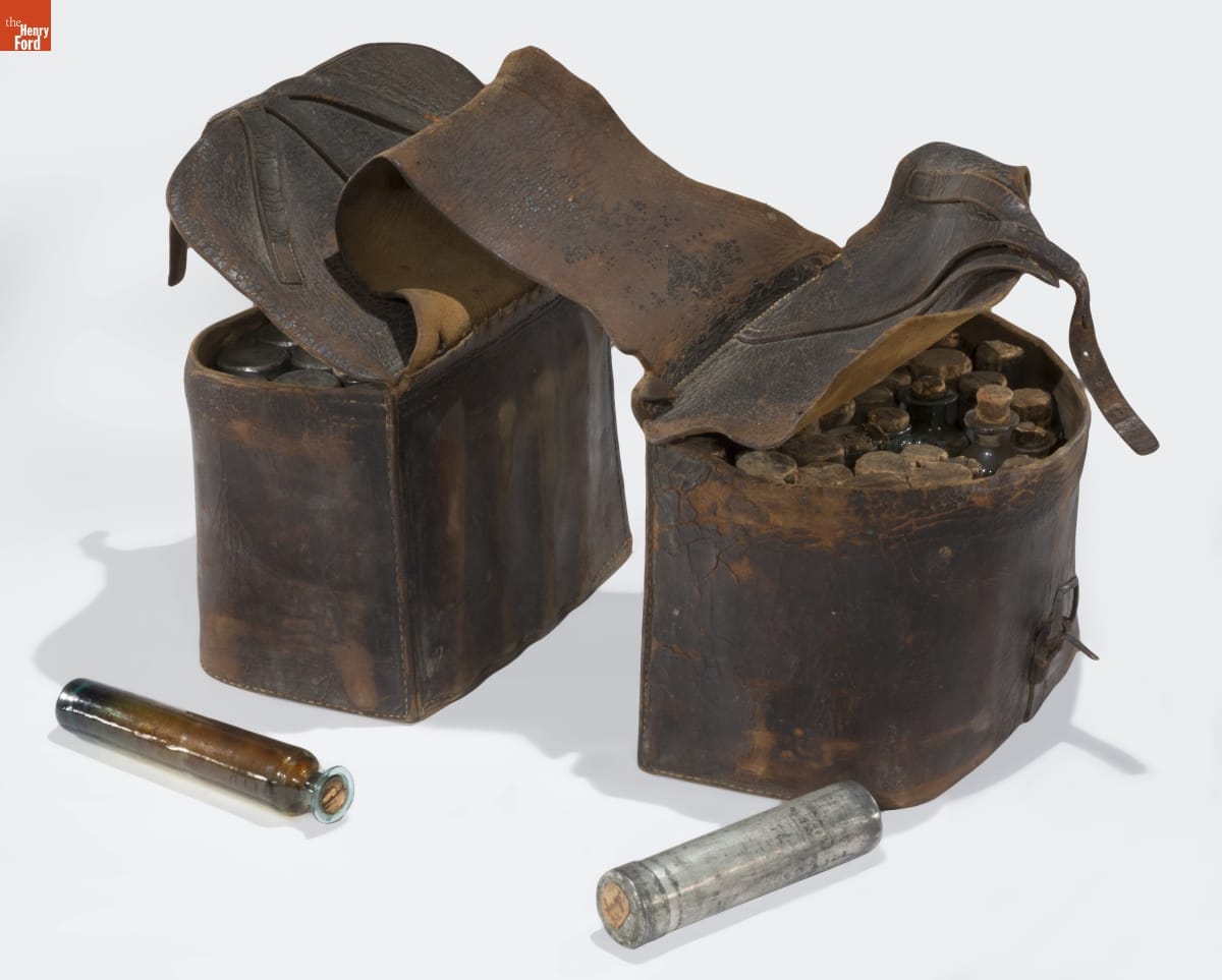 Black leather saddlebag filled with vials