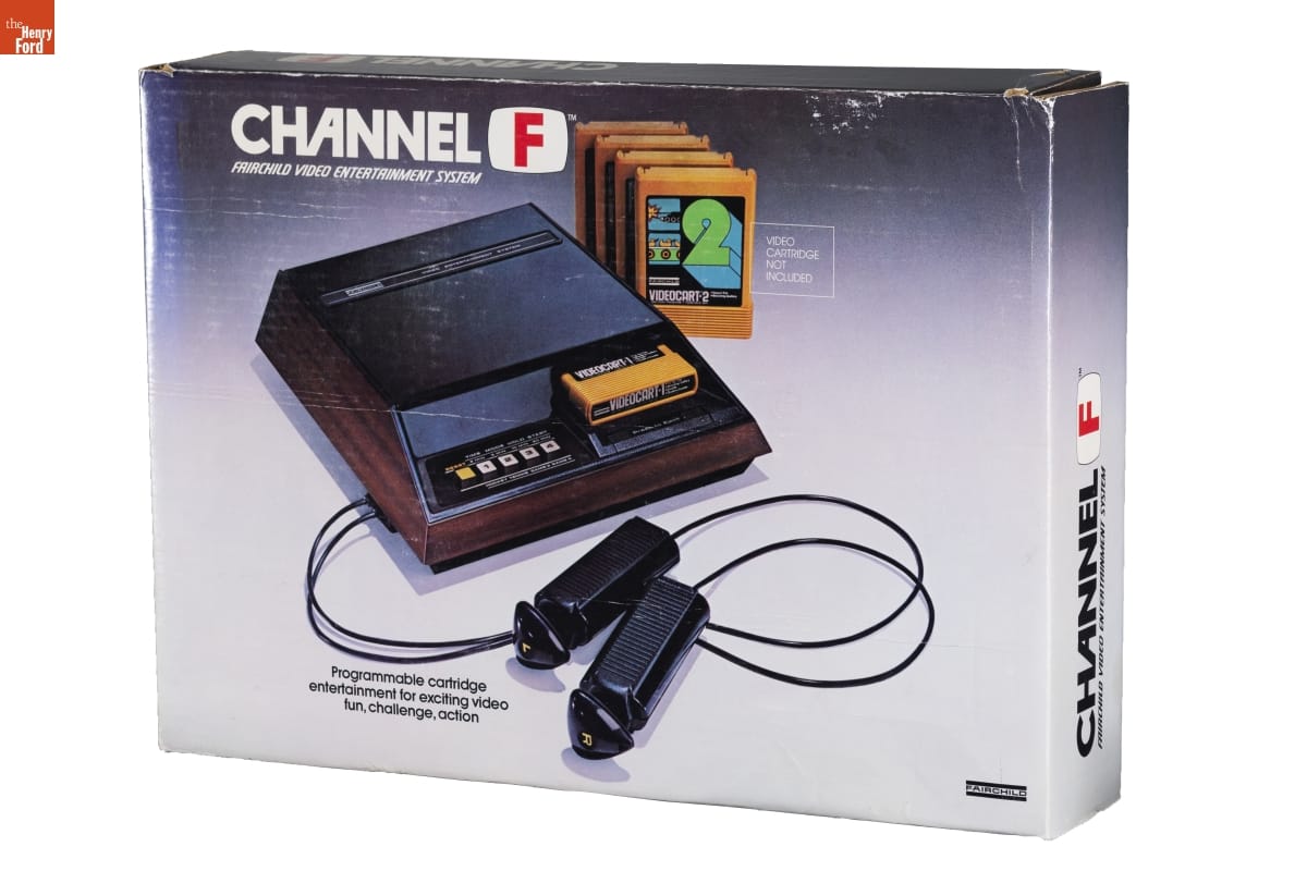 Fairchild Channel F Video Game System, 1976 Box with image of boxy video game system, cartridges, and stick controllers, along with text