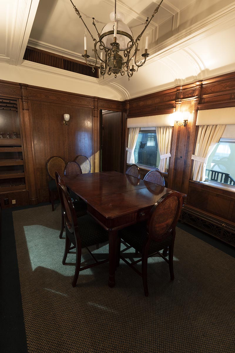 Henry Ford's Private Railroad Car Interior of room with wood paneling, arched ceiling, dining table, and chairs