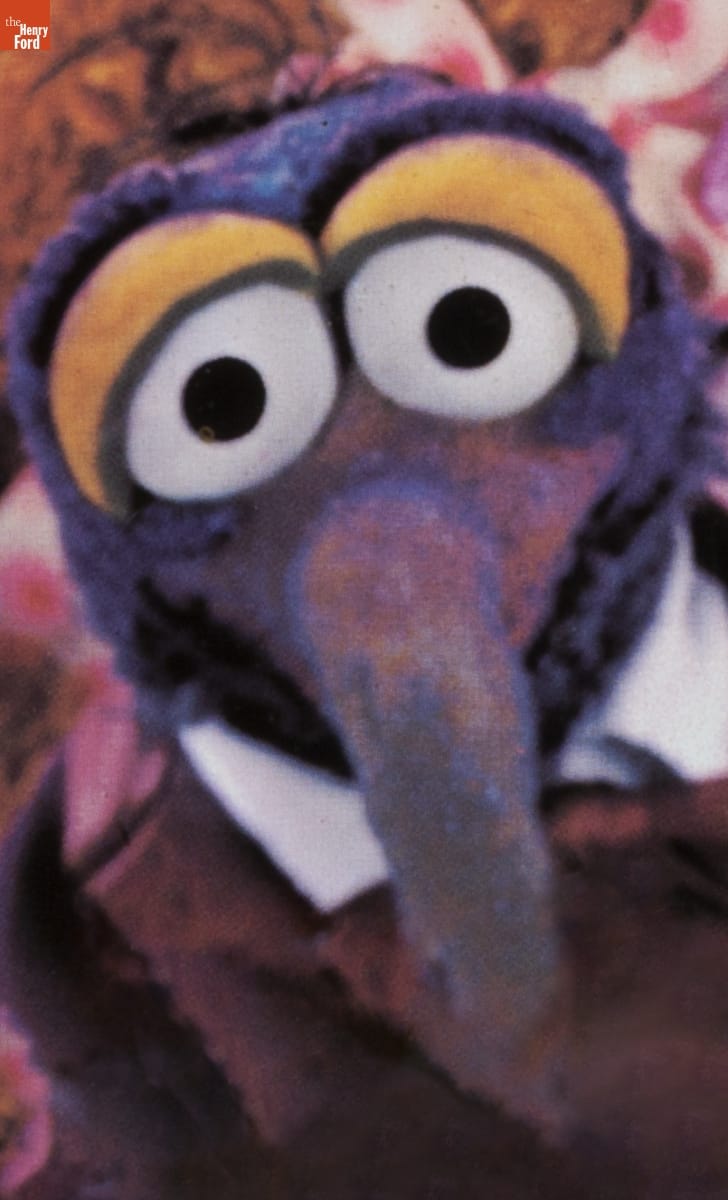 THF187306 / Head and shoulders of purple puppet with long hooked nose and large eyes