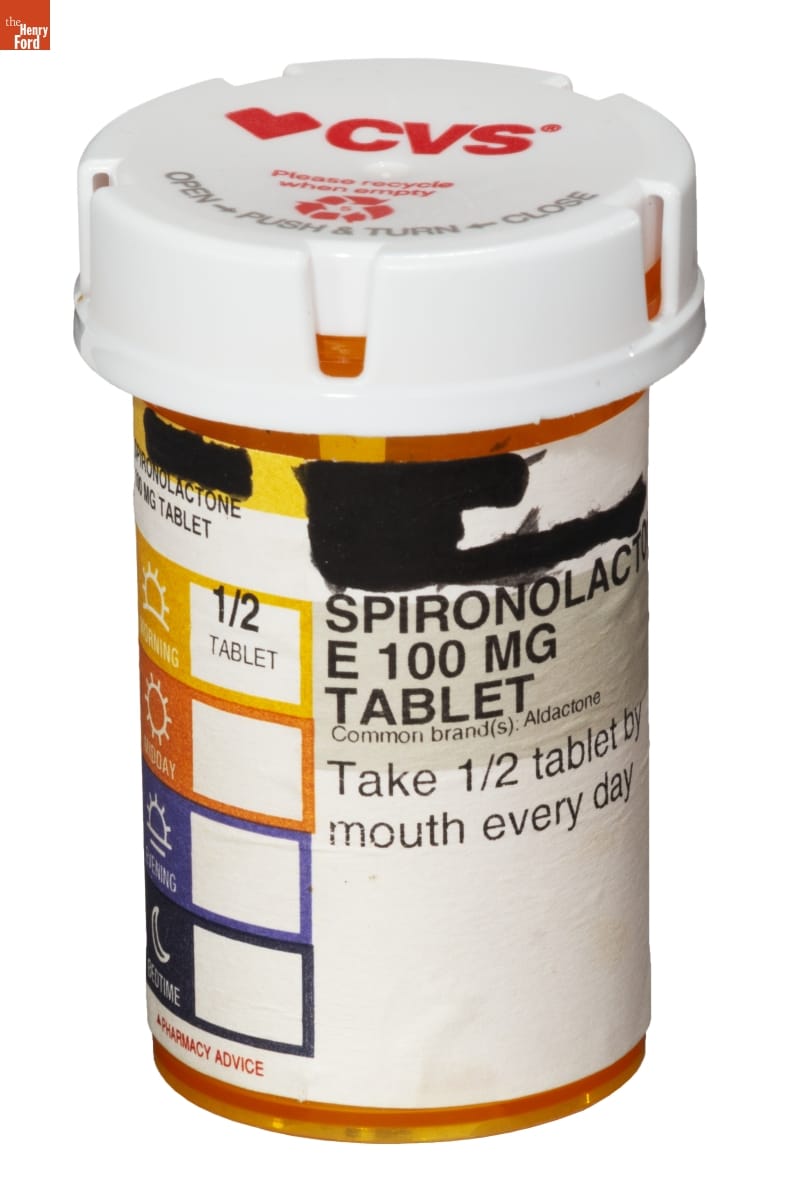 Spironolactone 100 Mg Tablet Pill Bottle, 2020 Orange plastic prescription bottle with white lid and white label containing text (some of which is blacked out)