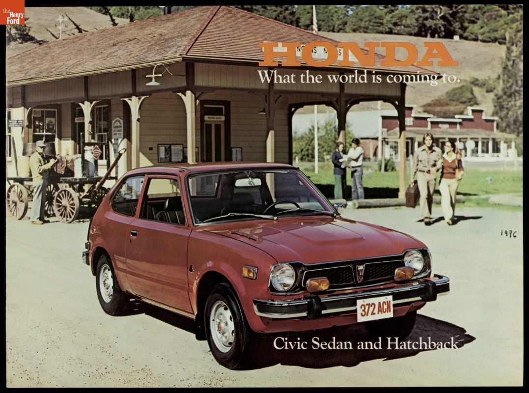 1977 Honda Civic Sedan and Hatchback, Page with text and photo of small red/brown car parked in front of a wooden building with people and a carriage nearby