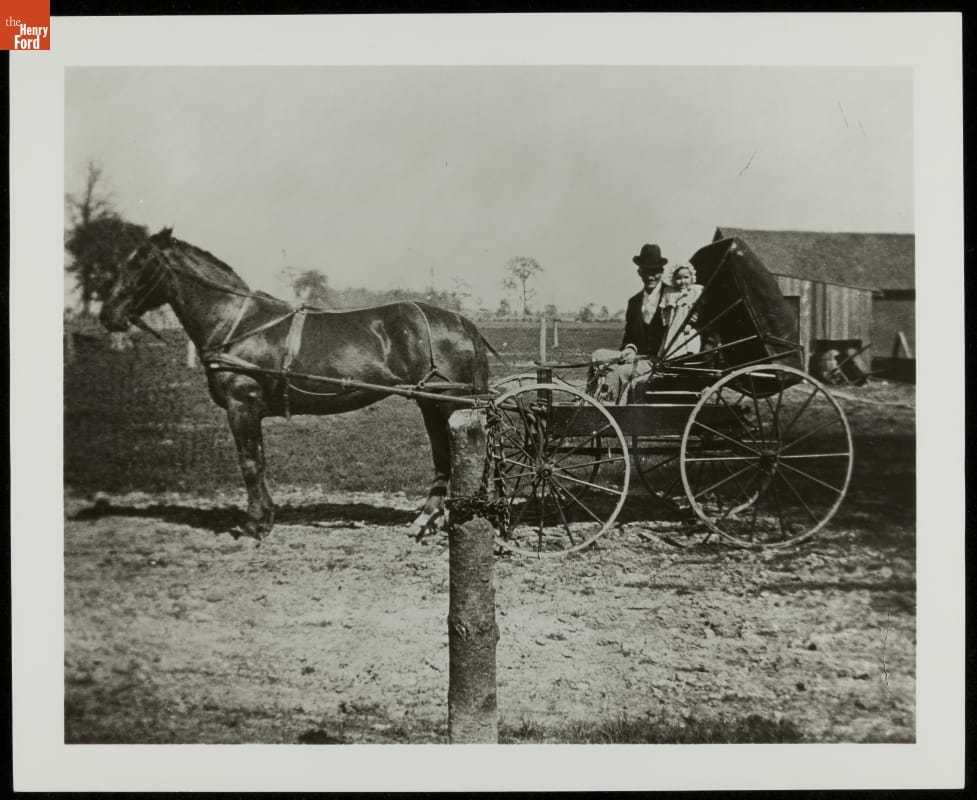 Milton Bryant with Nephew Edsel Ford in a Horse-Drawn Buggy, 1894 Man in suit and hat with child in an open buggy hitched to a horse, in front of a field