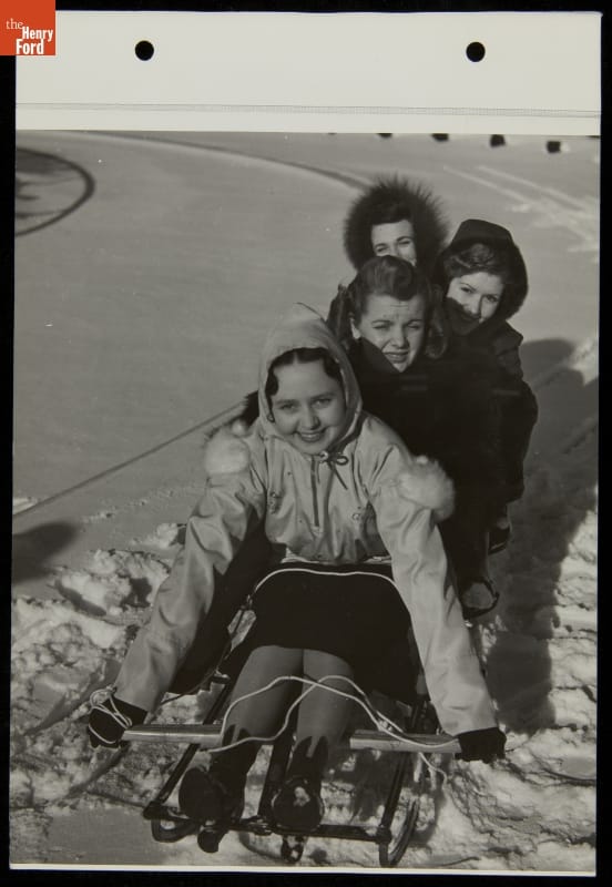 Women Sledding on Snow on Four women in a sled on a bed of snow