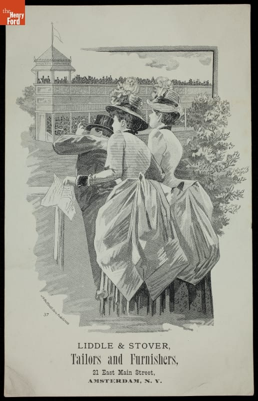 Two women and one man crane to watch off-page action; grandstands of fans in background