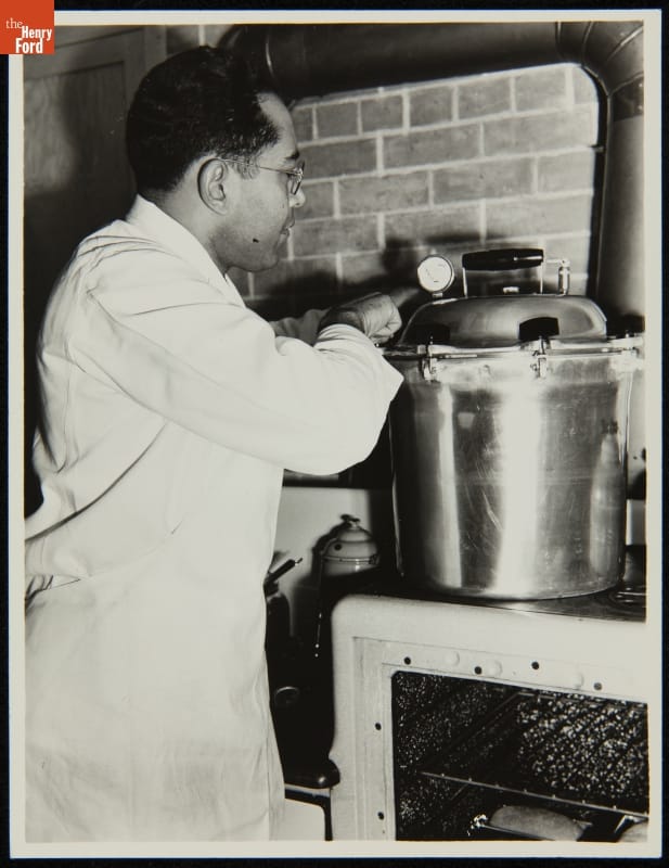 Worker in the Soybean Laboratory in Greenfield Village, Dearborn, Michigan, circa 1935 Man in white apron works at a pressure cooker