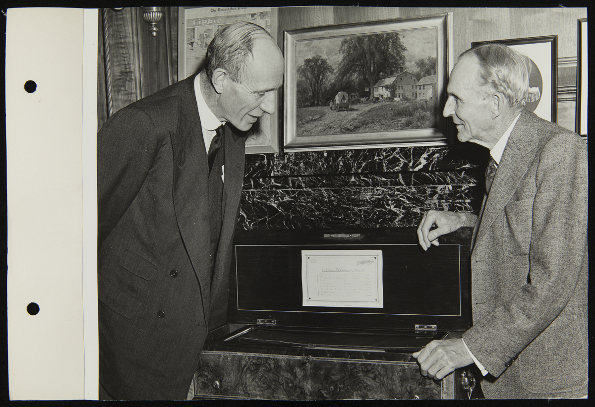 Lord Halifax and Henry Ford Meeting in Henry Ford's Office at the Engineering Laboratory, November 1941 Two men talk over an open box in an office; one peers in
