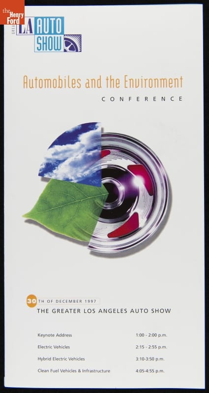 Hubcap overlaid with leaf and arc of blue sky with clouds, all on white background; contains text