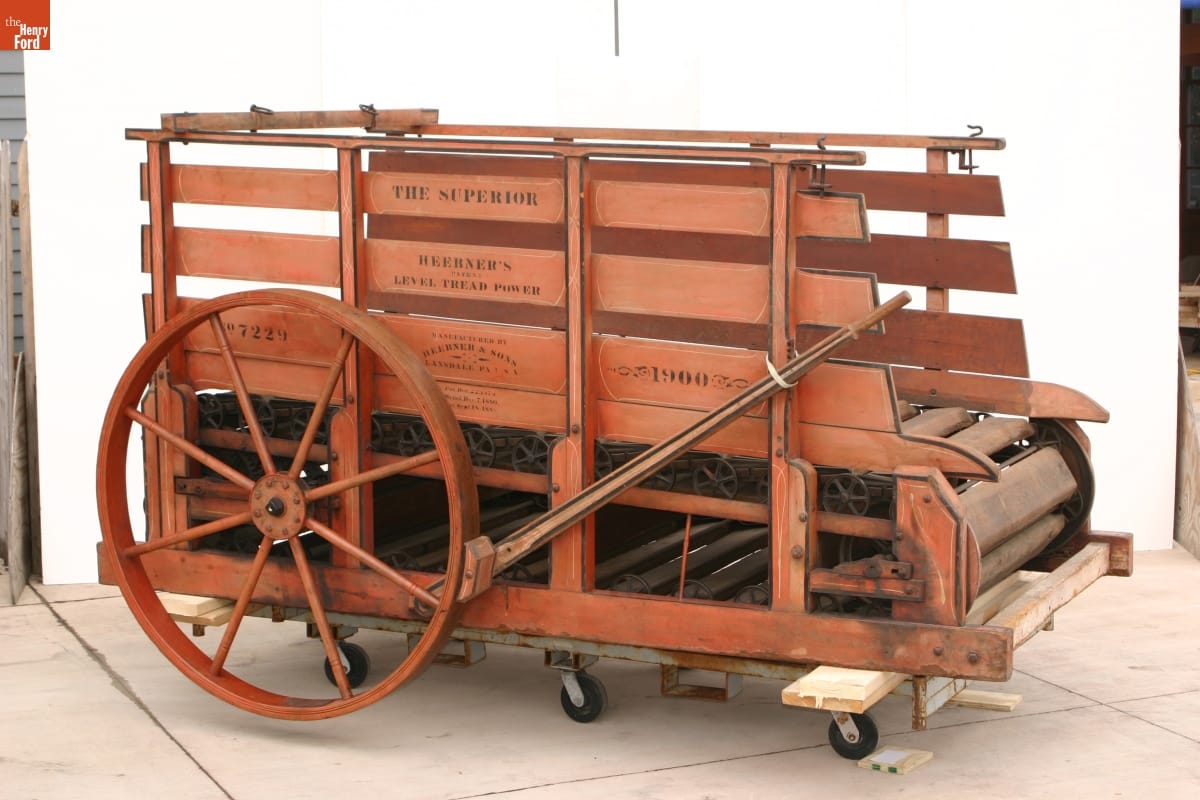 Wooden cart or wagon with two wheels and a wooden treadmill at the bottom