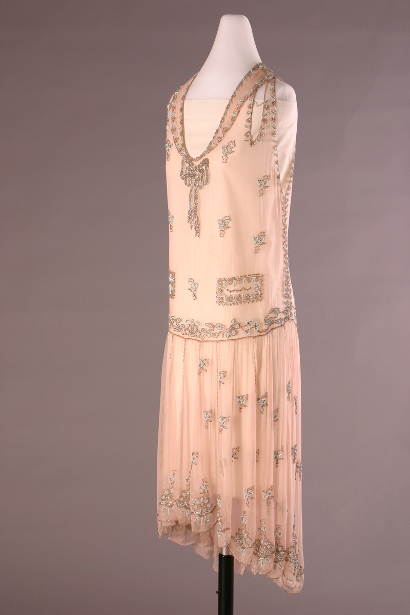 Peach-colored shift dress with beaded detailing