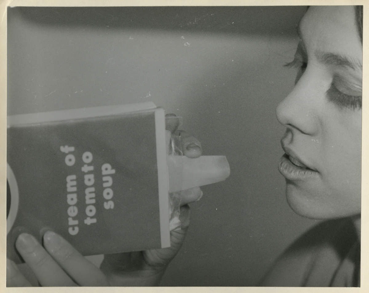 Woman holds box labeled 