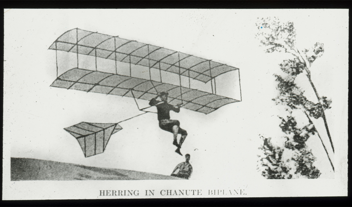Herring in Chanute Biplane,' 1896. Augustus Herring was an American aviation pioneer who collaborated with Octave Chaunte and built his own flyers. Herring piloted Chaunte’s glider during an 1896 test on the shores of Lake Michigan