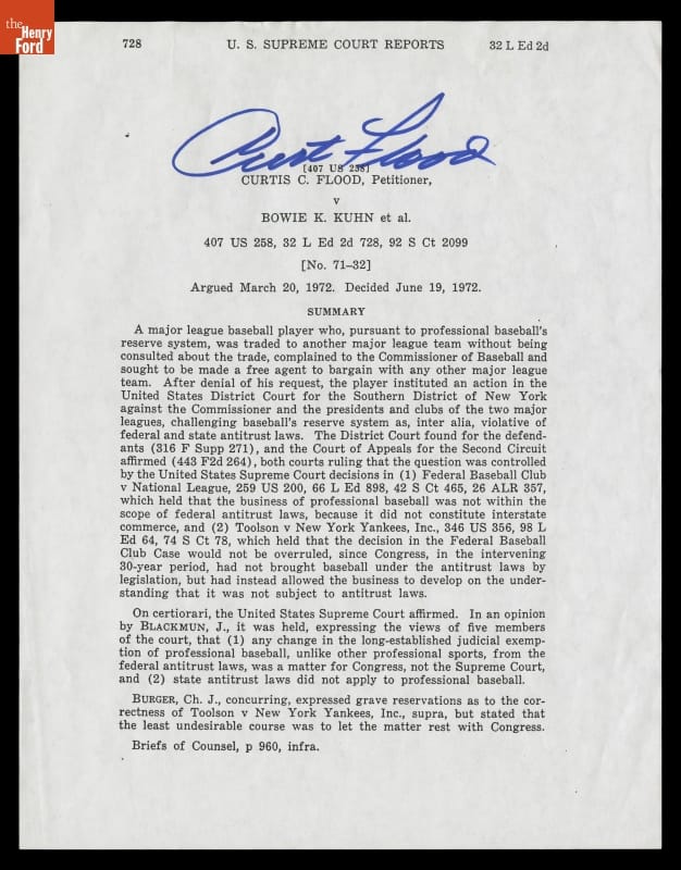 Page with typewritten text and large hand-written signature at top